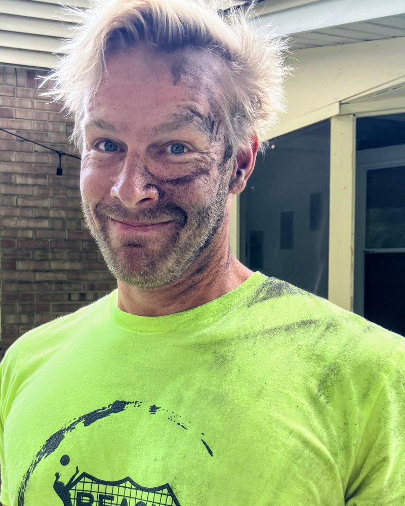 Jared grinning, face covered in soot